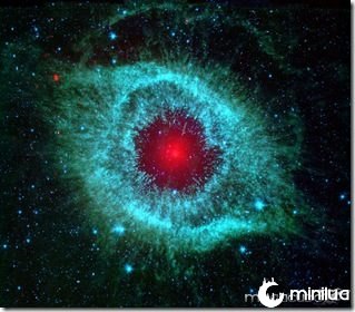 This infrared image from NASA's Spitzer Space Telescope shows the 
Helix nebula, a cosmic starlet often photographed by amateur astronomers
 for its vivid colors and eerie resemblance to a giant eye. The 
nebula, located about 700 light-years away in the constellation 
Aquarius, belongs to a class of objects called planetary nebulae. 
Discovered in the 18th century, these cosmic butterflies were named for 
their resemblance to gas-giant planets. Planetary nebulae are actually
 the remains of stars that once looked a lot like our sun. When 
sun-like stars die, they puff out their outer gaseous layers. These 
layers are heated by the hot core of the dead star, called a white 
dwarf, and shine with infrared and visible-light colors. Our own sun 
will blossom into a planetary nebula when it dies in about five billion 
years. In Spitzer's infrared view of the Helix nebula, the eye looks 
more like that of a green monster's. Infrared light from the outer 
gaseous layers is represented in blues and greens. The white dwarf is 
visible as a tiny white dot in the center of the picture. The red color 
in the middle of the eye denotes the final layers of gas blown out when 
the star died. The brighter red circle in the very center is the glow 
of a dusty disk circling the white dwarf (the disk itself is too small 
to be resolved). This dust, discovered by Spitzer's infrared 
heat-seeking vision, was most likely kicked up by comets that survived 
the death of their star. Before the star died, its comets and possibly 
planets would have orbited the star in an orderly fashion. But when the 
star blew off its outer layers, the icy bodies and outer planets would 
have been tossed about and into each other, resulting in an ongoing 
cosmic dust storm. Any inner planets in the system would have burned up 
or been swallowed as their dying star expanded. The Helix nebula is 
one of only a few dead-star systems in which evidence for comet 
survivors has been found. This image is made up of data from Spitzer's
 infrared array camera and multiband imaging photometer. Blue shows 
infrared light of 3.6 to 4.5 microns; green shows infrared light of 5.8 
to 8 microns; and red shows infrared light of 24 microns. 