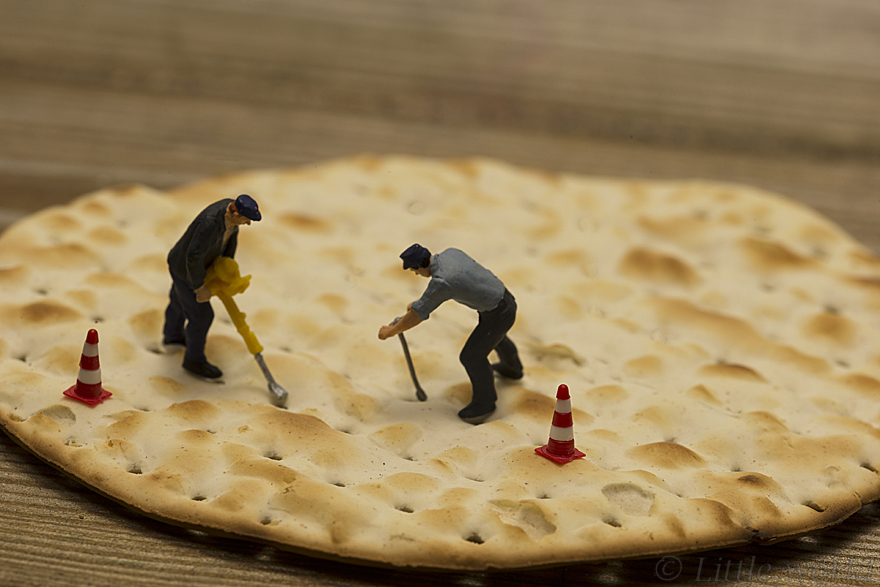 little people making holes in crackers for production